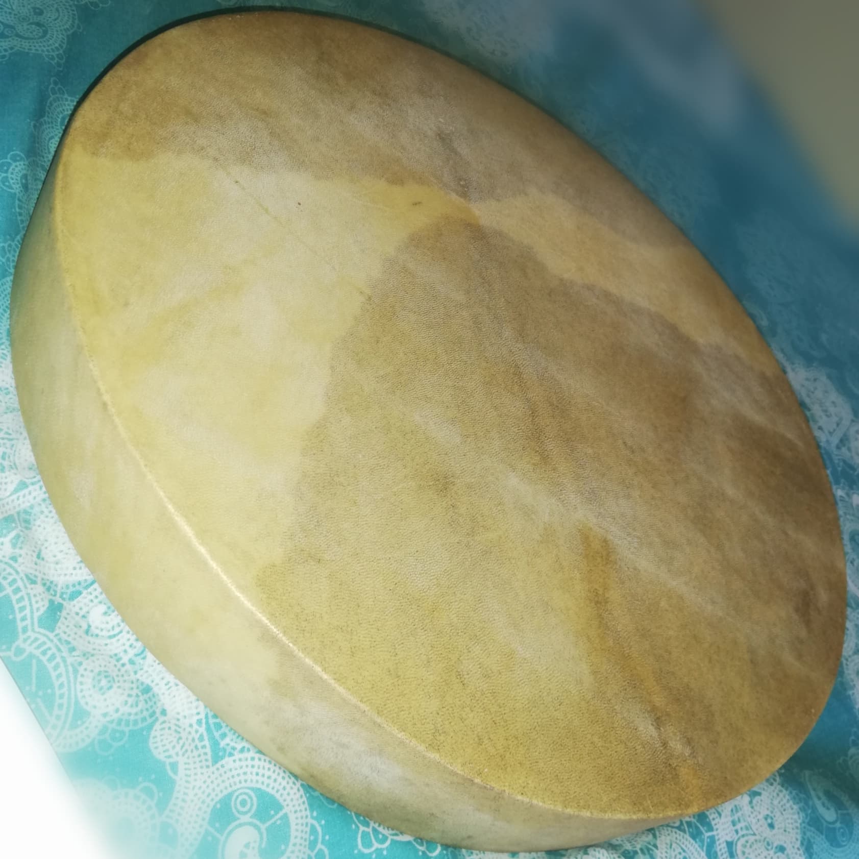 Round goatskin ravanne on a patterned cloth